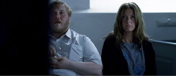 Movie still from “Adam's Apples” (2005), directed by Anders Thomas Jensen – A man and a woman sitting next to each other; Medium shot, Over the shoulder angle