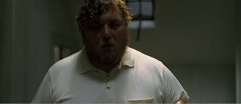 Movie still from “Adam's Apples” (2005), directed by Anders Thomas Jensen – A person wearing a white shirt; Close Up shot, Low angle