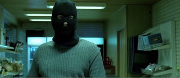 Movie still from “Adam's Apples” (2005), directed by Anders Thomas Jensen – A man wearing a balaclava and a sweater; Close Up shot, Low angle