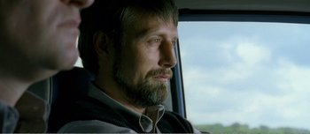 Movie still from “Adam's Apples” (2005), directed by Anders Thomas Jensen – A person in a car looking out the window; Close Up shot, Over the shoulder angle