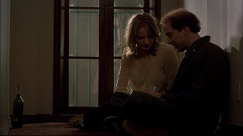 Movie still from “Adaptation.” (2002), directed by Spike Jonze – A man and a woman sitting next to each other on the floor; Medium shot, Low angle