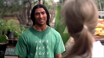 Movie still from “Adaptation.” (2002), directed by Spike Jonze – A man in a green shirt is talking to a woman; Close Up shot, Over the shoulder angle