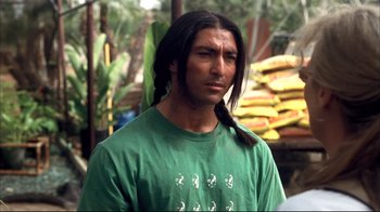 Movie still from “Adaptation.” (2002), directed by Spike Jonze – A man with long black hair wearing a green shirt; Close Up shot, Over the shoulder angle