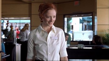 Movie still from “Adaptation.” (2002), directed by Spike Jonze – A woman with red hair wearing a white shirt; Medium shot, Over the shoulder angle