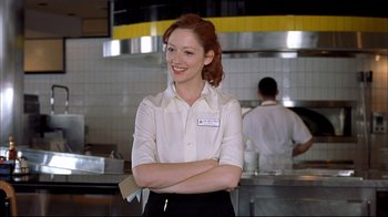 Movie still from “Adaptation.” (2002), directed by Spike Jonze – A woman standing in front of a counter in a kitchen; Medium shot, Low angle