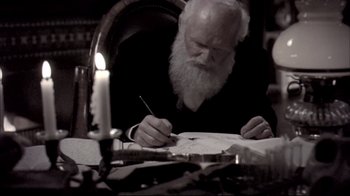 Movie still from “Adaptation.” (2002), directed by Spike Jonze – An old man writing on a piece of paper; Medium shot, High angle