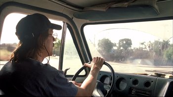 Movie still from “Adaptation.” (2002), directed by Spike Jonze – A man driving a car on the street; Medium shot, Over the shoulder angle