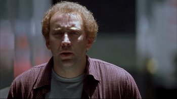 Movie still from “Adaptation.” (2002), directed by Spike Jonze – A person wearing a plaid shirt; Close Up shot, Low angle