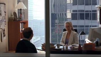 Movie still from “Adaptation.” (2002), directed by Spike Jonze – Two women sitting at a table in front of a large window; Wide shot, Over the shoulder angle