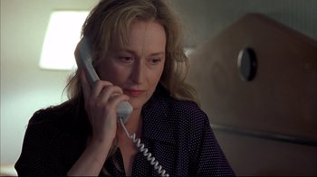 Movie still from “Adaptation.” (2002), directed by Spike Jonze – A woman talking on a phone while sitting in a chair; Close Up shot, High angle