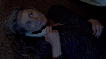 Movie still from “Adaptation.” (2002), directed by Spike Jonze – A woman laying on the ground talking on a phone; Close Up shot, Overhead angle