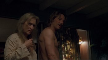 Movie still from “Adaptation.” (2002), directed by Spike Jonze – A man and a woman standing next to each other in a room; Medium shot, Over the shoulder angle