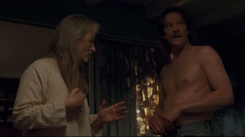 Movie still from “Adaptation.” (2002), directed by Spike Jonze – A man and a woman are talking in a room; Medium shot, Over the shoulder angle