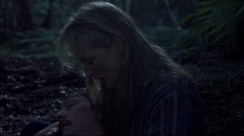 Movie still from “Adaptation.” (2002), directed by Spike Jonze – Two people in the woods , one of whom is laying on the ground and the other is kissing; Close Up shot, Low angle