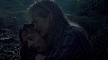 Movie still from “Adaptation.” (2002), directed by Spike Jonze – A man and a woman snuggling in the dark; Close Up shot, High angle