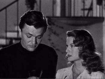 Movie still from “Address Unknown” (1944), directed by William Cameron Menzies – A man and a woman looking at each other; Medium shot, Over the shoulder angle