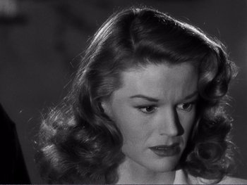 Movie still from “Address Unknown” (1944), directed by William Cameron Menzies – A black and white photo of a woman with long hair; Close Up shot, Low angle