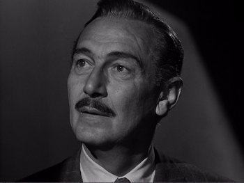 Movie still from “Address Unknown” (1944), directed by William Cameron Menzies – An older man wearing a suit and a tie; Close Up shot, Low angle