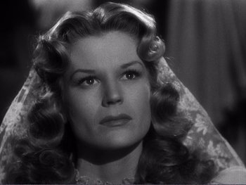 Movie still from “Address Unknown” (1944), directed by William Cameron Menzies – An old photo of a woman with long curly hair; Close Up shot, Low angle