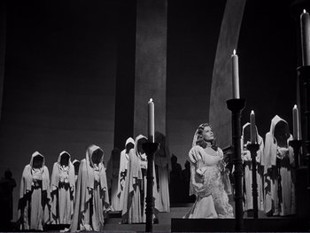 Movie still from “Address Unknown” (1944), directed by William Cameron Menzies – A black and white photo of a group of people dressed as nuns; Wide shot, High angle
