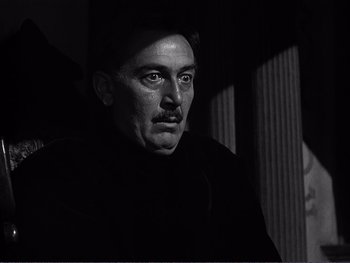 Movie still from “Address Unknown” (1944), directed by William Cameron Menzies – A black and white photo of a man with a mustache; Close Up shot, Low angle