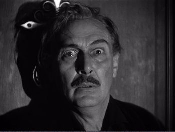 Movie still from “Address Unknown” (1944), directed by William Cameron Menzies – An older man with a mustache stares at the camera; Close Up shot, Low angle