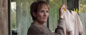 Movie still from “Adult Life Skills” (2016), directed by Rachel Tunnard – A person holding a yellow object; Close Up shot, Over the shoulder angle
