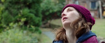Movie still from “Adult Life Skills” (2016), directed by Rachel Tunnard – A woman wearing a pink hat looking up at the sky; Close Up shot, Low angle