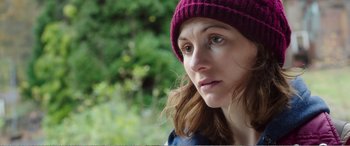 Movie still from “Adult Life Skills” (2016), directed by Rachel Tunnard – A person wearing a hat; Close Up shot, Over the shoulder angle