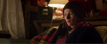 Movie still from “Adult Life Skills” (2016), directed by Rachel Tunnard – A woman sitting in a chair in a dark room; Medium shot, Over the shoulder angle