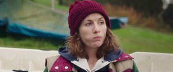 Movie still from “Adult Life Skills” (2016), directed by Rachel Tunnard – A person wearing a jacket and a hat; Close Up shot, Over the shoulder angle