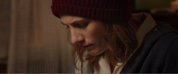 Movie still from “Adult Life Skills” (2016), directed by Rachel Tunnard – A person wearing a hat; Close Up shot, Over the shoulder angle