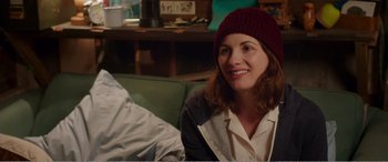 Movie still from “Adult Life Skills” (2016), directed by Rachel Tunnard – A woman wearing a hat sitting on a couch; Close Up shot, Over the shoulder angle