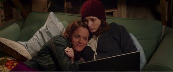 Movie still from “Adult Life Skills” (2016), directed by Rachel Tunnard – Two women are looking at a laptop computer; Medium shot, Over the shoulder angle