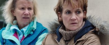 Movie still from “Adult Life Skills” (2016), directed by Rachel Tunnard – A woman wearing a jacket and a scarf; Close Up shot, Over the shoulder angle