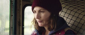 Movie still from “Adult Life Skills” (2016), directed by Rachel Tunnard – A person wearing a hat; Close Up shot, Over the shoulder angle