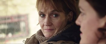 Movie still from “Adult Life Skills” (2016), directed by Rachel Tunnard – A person wearing a jacket; Close Up shot, Over the shoulder angle
