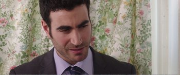 Movie still from “Adult Life Skills” (2016), directed by Rachel Tunnard – A person wearing a suit and tie; Close Up shot, Over the shoulder angle