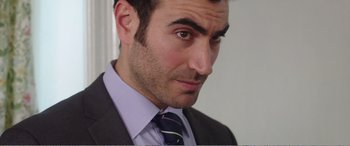 Movie still from “Adult Life Skills” (2016), directed by Rachel Tunnard – A person wearing a suit and tie; Close Up shot, Over the shoulder angle