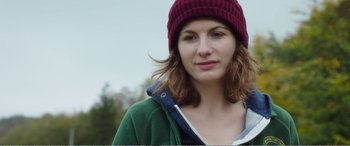 Movie still from “Adult Life Skills” (2016), directed by Rachel Tunnard – A person wearing a hat; Close Up shot, Over the shoulder angle