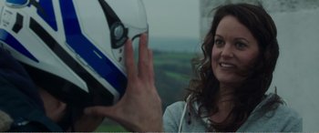 Movie still from “Adult Life Skills” (2016), directed by Rachel Tunnard – A woman giving a high five to a person wearing a helmet; Close Up shot, Over the shoulder angle