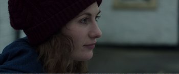 Movie still from “Adult Life Skills” (2016), directed by Rachel Tunnard – A person wearing a hat; Close Up shot, Over the shoulder angle