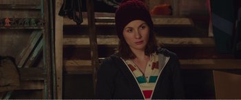 Movie still from “Adult Life Skills” (2016), directed by Rachel Tunnard – A woman wearing a red hat and a striped shirt; Close Up shot, Over the shoulder angle