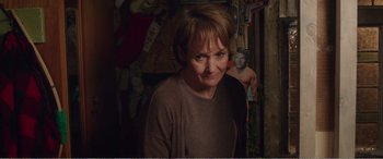 Movie still from “Adult Life Skills” (2016), directed by Rachel Tunnard – A woman standing in front of a wall with stuffed animals on it; Close Up shot, Over the shoulder angle