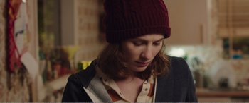 Movie still from “Adult Life Skills” (2016), directed by Rachel Tunnard – A woman wearing a red hat looking down at her face; Close Up shot, Over the shoulder angle