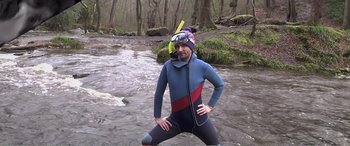 Movie still from “Adult Life Skills” (2016), directed by Rachel Tunnard – A man in a wetsuit and a scuba mask in the water; Wide shot, Over the shoulder angle