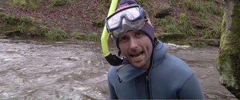 Movie still from “Adult Life Skills” (2016), directed by Rachel Tunnard – A man in a wet suit with goggles and a snorkel in the water; Medium shot, Over the shoulder angle