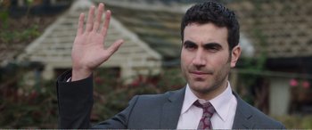 Movie still from “Adult Life Skills” (2016), directed by Rachel Tunnard – A person wearing a suit and tie; Close Up shot, Over the shoulder angle