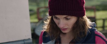 Movie still from “Adult Life Skills” (2016), directed by Rachel Tunnard – A person wearing a hat; Close Up shot, Over the shoulder angle