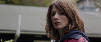 Movie still from “Adult Life Skills” (2016), directed by Rachel Tunnard – A person with long brown hair; Close Up shot, Over the shoulder angle